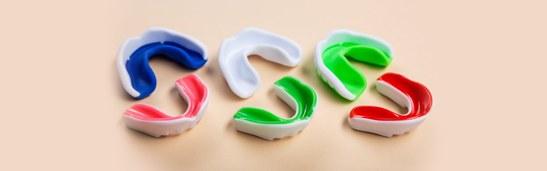 How do mouth guards protect against sports-related dental injuries?